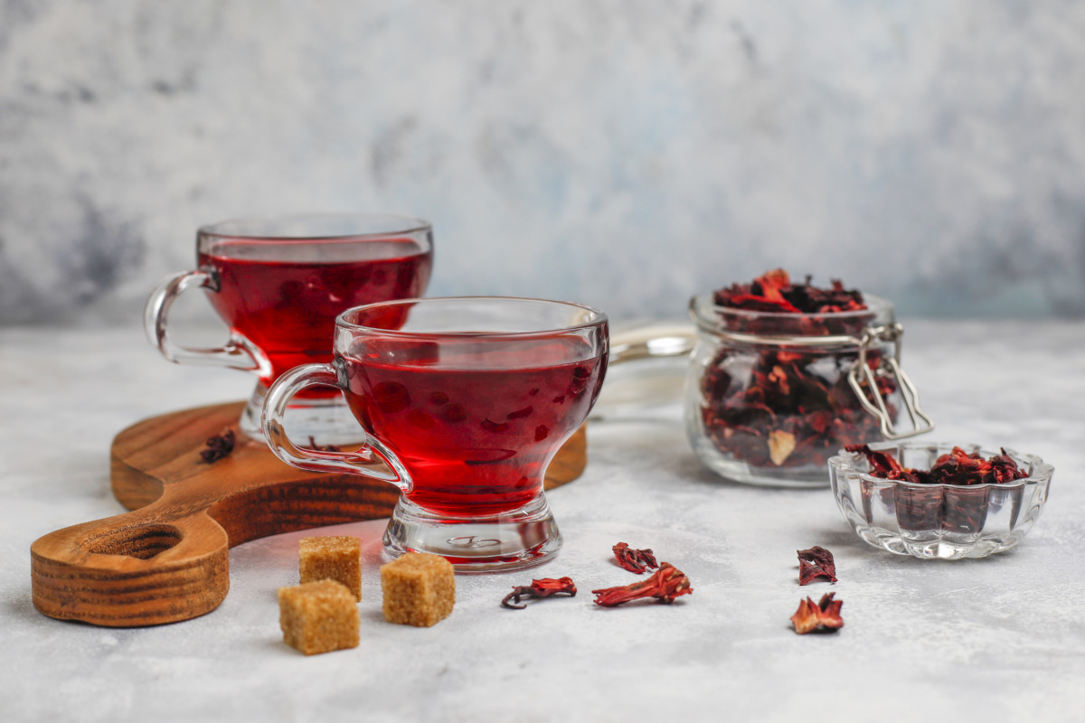 Red Hot Hibiscus tea in a glass mug on concrete background with