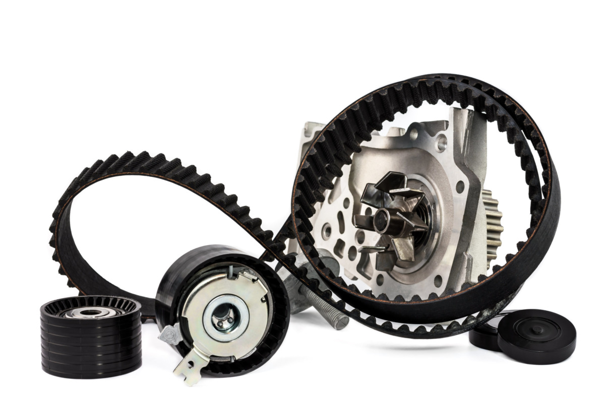Kit of timing belt with rollers and pump on a white background